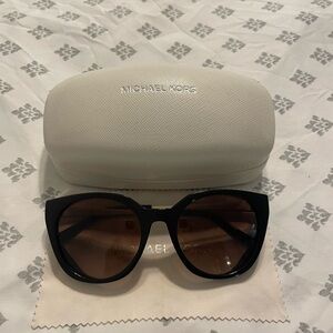 Black Michael Kors sunglasses with gold arms.